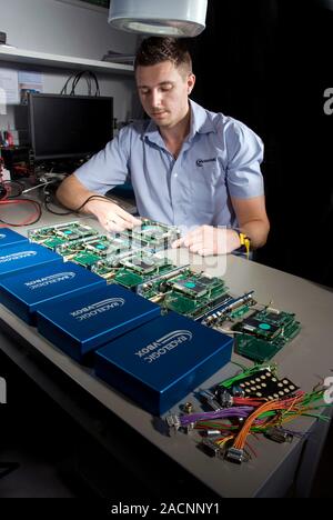 Automotive testing industry. Engineer testing and assembling components for devices used in motorsport racing and automobile testing. The devices bein Stock Photo