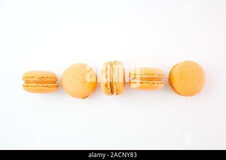 Macaroons on white background top, colorful yellow macaroons, selective focus. Stock Photo