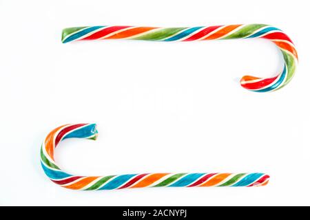 Two colorful festive Lollipop in form of frame on white background selective focus top of view. Stock Photo