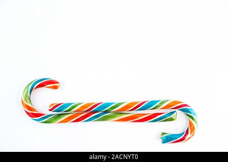 Two colorful festive Lollipop on white background selective focus top of view. Stock Photo