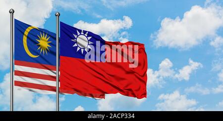 Taiwan and Malaysia flag waving in the wind against white cloudy 