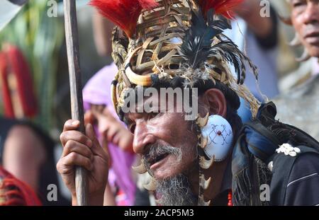 Kohima, India. 03 Dec 2019: An elderly Naga man in his traditional attires watch other performance on the third day of the State annual Hornbill festival at Naga Heritage Village Kisama, some 15 kms away from Kohima, the capital city of the India north eastern state of Nagaland. The annual Hornbill festival of Nagaland celebrates the cultural heritage of the Nagas. Credit: Caisii Mao/Alamy Live News Stock Photo