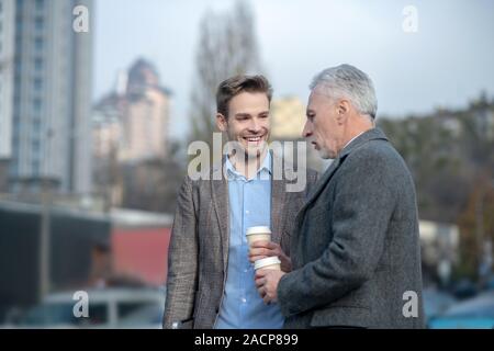 Young businessman and his mature mentor having a conversation Stock Photo