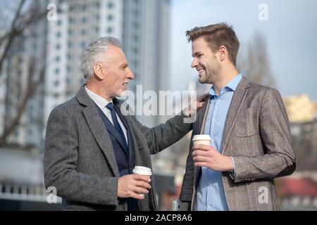 Young businessman and his mature mentor having a conversation Stock Photo