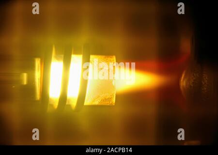 Analysis of concrete. Plasma emission spectrometry being used to analyse a mineral solution used in concrete and cement. Here, the flame used to heat Stock Photo