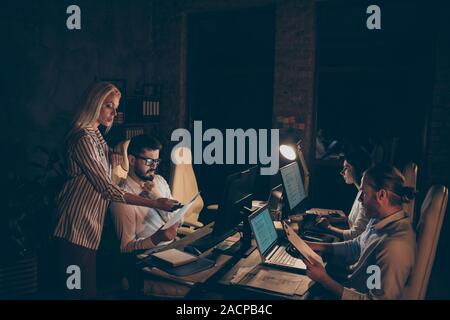 Profile side view of nice attractive focused concentrated coworkers experts specialists developing department statistics income analyzing report at Stock Photo