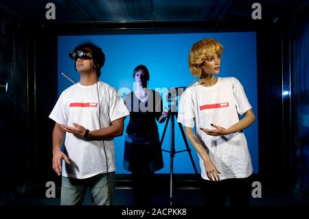 Out-of-body virtual reality research. Research using virtual reality to 'project' subjects into other bodies. The subject wears a virtual reality helm Stock Photo