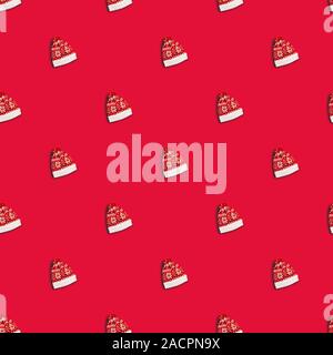 Christmas red hat with deers on red background, seamless pattern. Santa Claus hat Stock Photo
