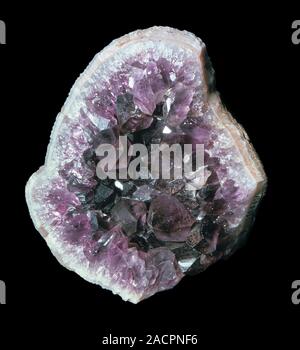 Amethyst geode interior. Amethyst crystals lining an agate geode. Amethyst is a gemstone variety of quartz. This specimen is from Germany. Stock Photo