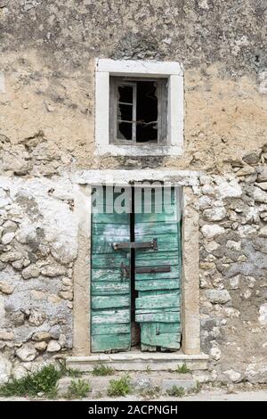 Entrance door of an abandoned house, Greece Stock Photo