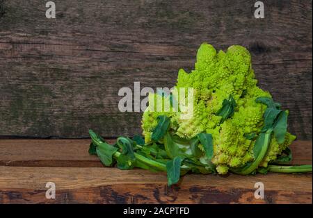 Fresh cabbage grade Romanesco on a wooden background, close-up Stock Photo