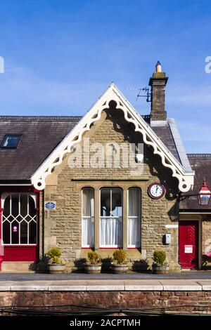 The gable end of the former booking office building on railway station at Kirkby Stephen in Cumbria, now used as self-catering holiday accomodation. Stock Photo