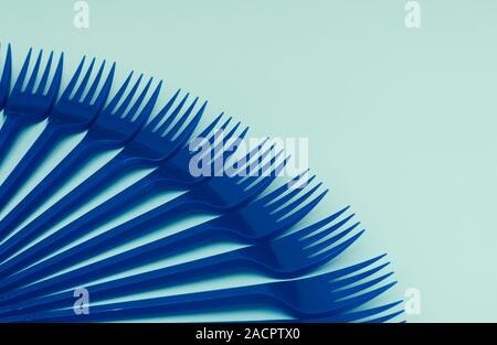 Blue plastic forks on a blue background, gorizontal orientation, copy space Stock Photo