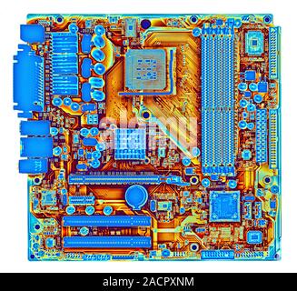 Computer motherboard, coloured x-ray of the main circuit board (motherboard) of a personal computer (PC). Motherboard components include transistors, Stock Photo