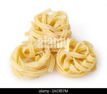 Uncooked nests of tagliatelle pasta isolated on white background with clipping path Stock Photo