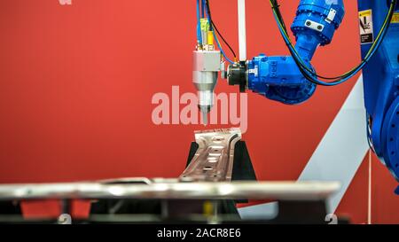 Robotic arms works on factory on manufacture of cars. Industrial robotic welders weld the car body. Machine robot arm. Smart industry. Automobile prod Stock Photo