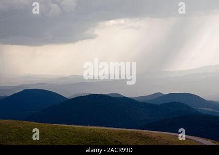 Storm with rain clouds over the Auvergne Volcanoes Natural Regional Park viewed from the summit of the Puy de Dome, France. Stock Photo