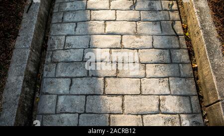 Top view on paving stone road. Old pavement of square cobblestone sidewalk in Taipei. Garden patio in backyard stone brick pavers in Taiwan. Concrete Stock Photo