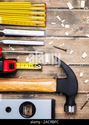 Top view of carpenter's tools on an antique wooden table. Construction industry, do it yourself. Wooden work table. Stock Photo