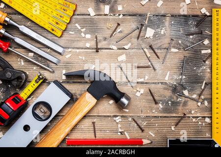 Top view of carpenter's tools on an antique wooden table. Construction industry, do it yourself. Wooden work table. Stock Photo