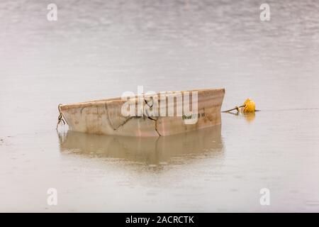 white plastic box floating in the water Stock Photo