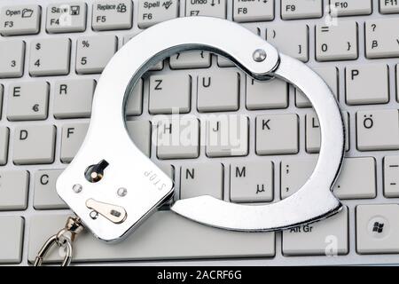 Handcuffs on Computer Keyboard Stock Photo