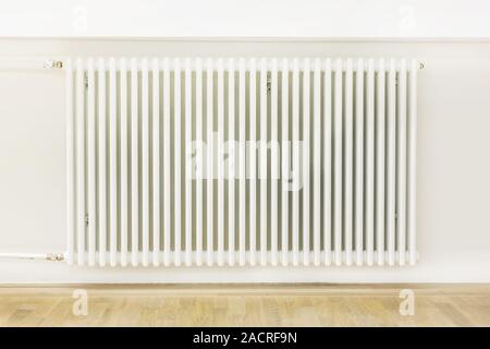 Large radiator in renovated room Stock Photo - Alamy