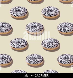 Food seamless isometric pattern with white glazed chocolate donuts on pastel beige background.Dessert fast food.Minimal abstract creative concept Stock Photo