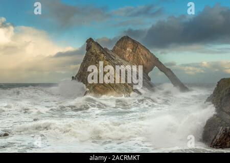 BOW FIDDLE ROCK PORTKNOCKIE MORAY SCOTLAND WINTER SEA WITH WIND CRASHING WAVES SPRAY AND FOAM Stock Photo