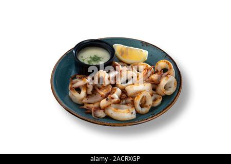 Delicious fried calamari with lemon and dressing with stylish vintage plate Stock Photo