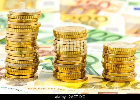 Stack of money coins, sinking curve Stock Photo