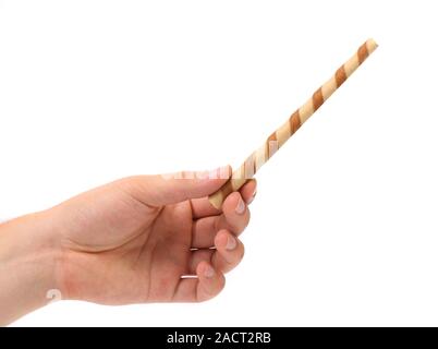 Hand holds striped chocolate wafer rolls Stock Photo