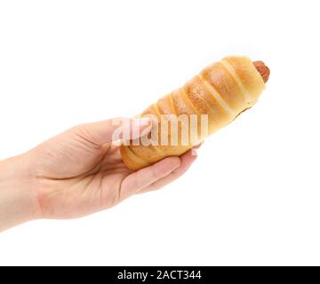 Hand holds hot dog baked. Stock Photo