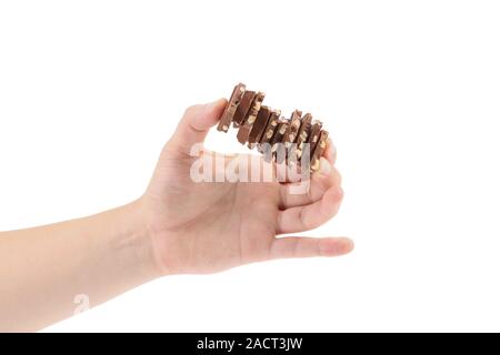 Hand holds milk chocolate with nuts. Stock Photo