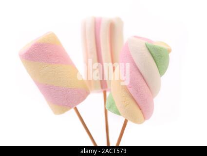 Three different colorful marshmallow on sticks. Stock Photo