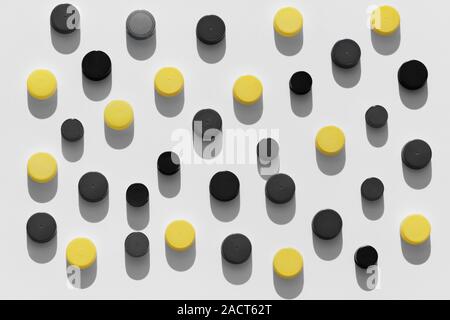 Plastic bottle caps background with black and yellow color random pattern on white background Stock Photo