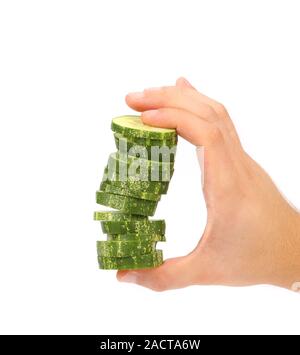 Hand holds stack of sliced cucumber. Stock Photo
