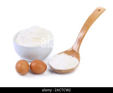 Spoon and bowl with flour, two eggs Stock Photo