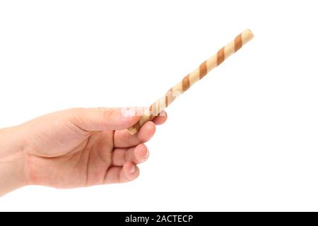 Hand holds striped chocolate wafer rolls Stock Photo