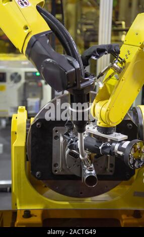6 axis industry robotic arc machine welding nipple to pipe Stock Photo