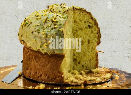 an exquisite Italian Christmas cake, panettone covered with pistachio cream Stock Photo