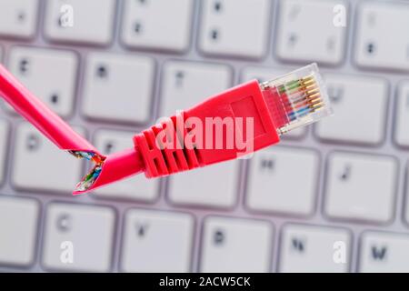 Defective network cable on keyboard Stock Photo