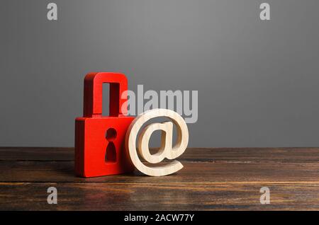 A red padlock and email symbol. preservation of secrets, information and values. Protection and insurance. Hacking attack. Safety of personal data, pr Stock Photo
