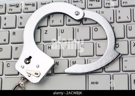 Handcuffs on Computer Keyboard Stock Photo