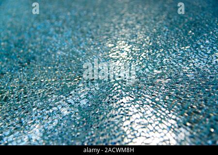 Broken tempered glass window. This strengthened glass window shattered as a result of extreme temperature changes due to the weather. The glass expand Stock Photo