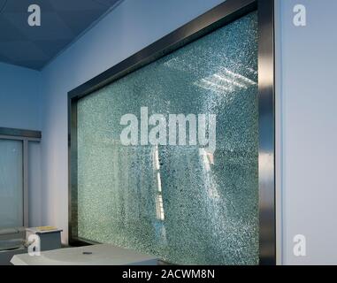 Broken tempered glass window. This strengthened glass window shattered as a result of extreme temperature changes due to the weather. The glass expand Stock Photo