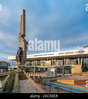 Sofia Central Station with Soviet era sculpture in the centre of a circular plaza. Opened in 1974 the station was designed by architect Milko Bechev. Stock Photo