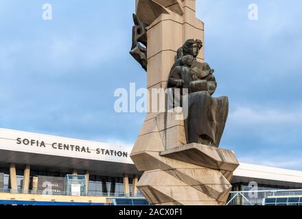 Sofia Central Station with Soviet era sculpture in the centre of a circular plaza. Opened in 1974 the station was designed by architect Milko Bechev. Stock Photo