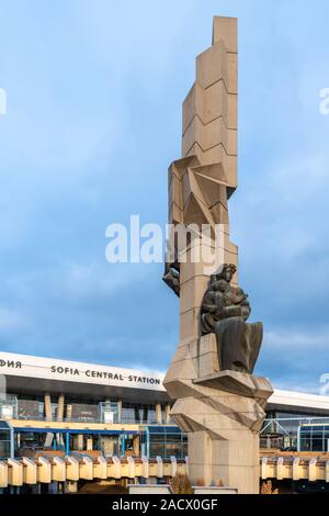 Sofia Central Station with Soviet era sculpture in the centre of a circular plaza. Opened in 1974 the station was designed by architect Milko Bechev. Stock Photo