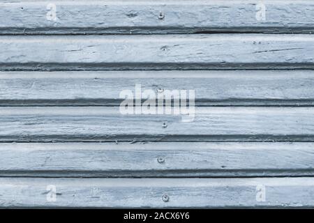 The ribbed texture of old wooden wall. Light gray pallets with nails. Painted wood planks. Stock Photo